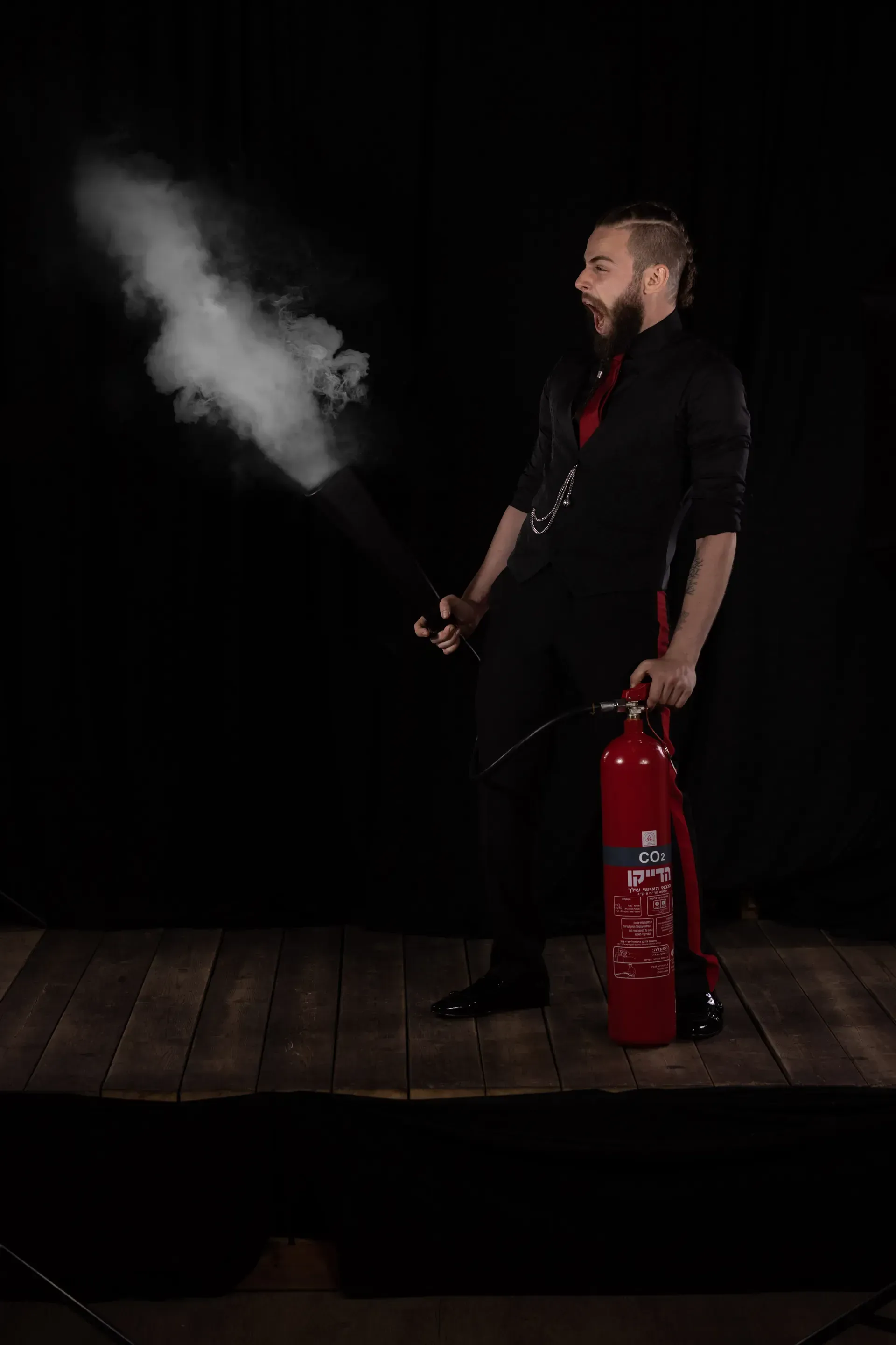 Lior Littman with a fire extinguisher and smoke